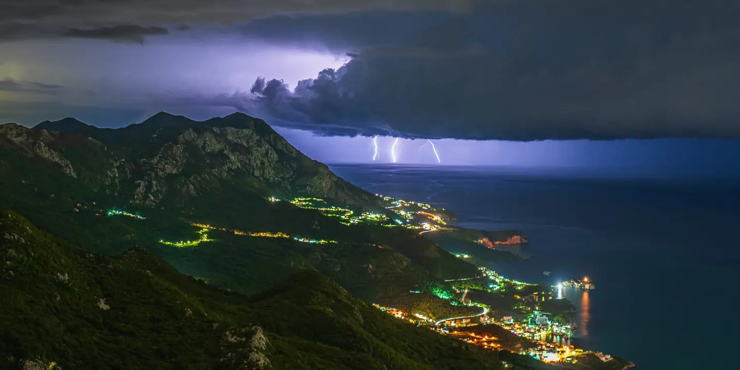 Twin lightning bolts slice through roiling storm clouds above the Adriatic Sea in this long-exposure night shot taken above Brajici near Budva on Montenegro's coast.