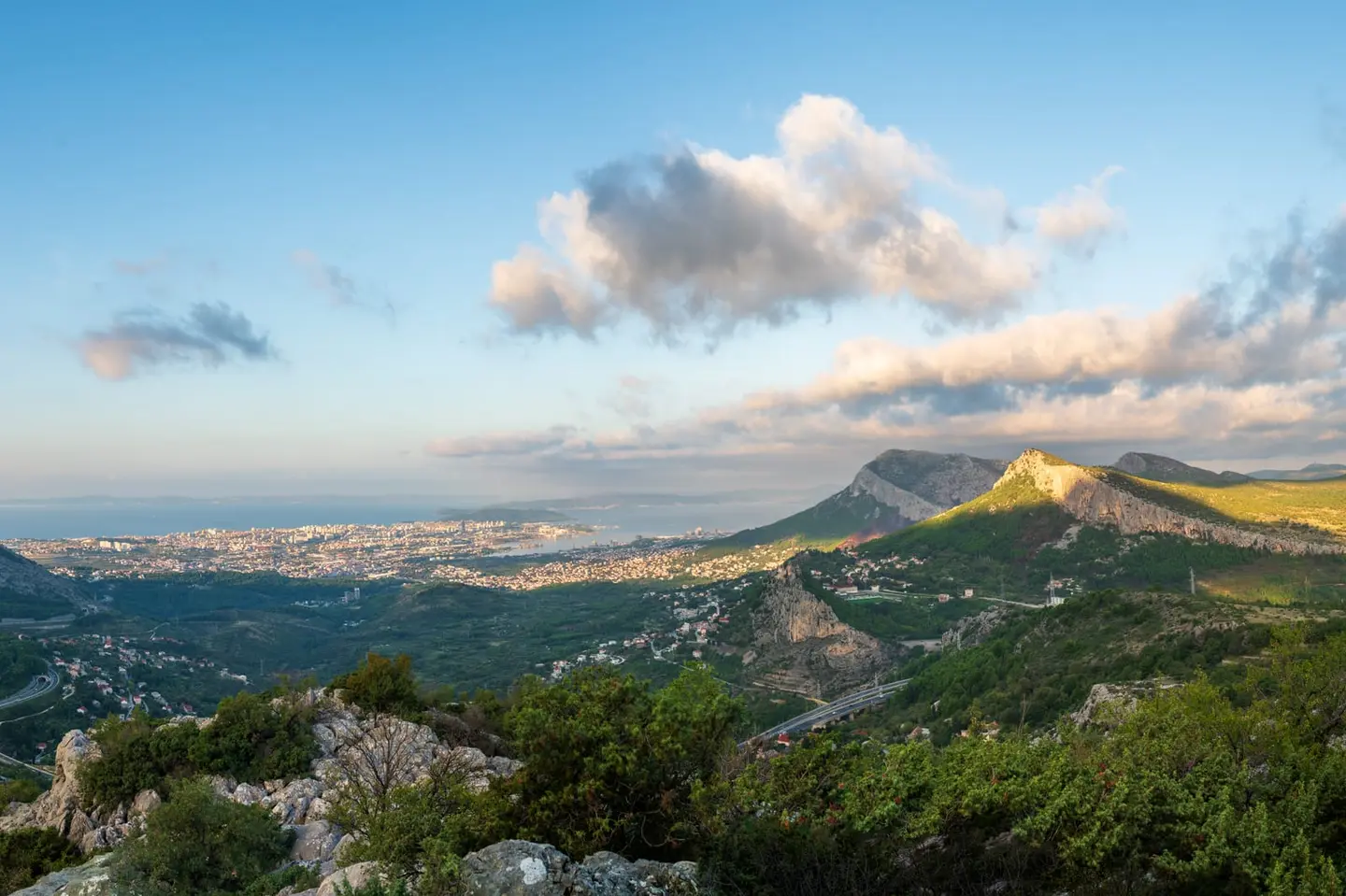 From the fortified heights above Klis, the full breadth of Split spreads below in warm September 2024 light — the ancient Roman grid of Diocletian's city, the port, and the Adriatic coast stretching…